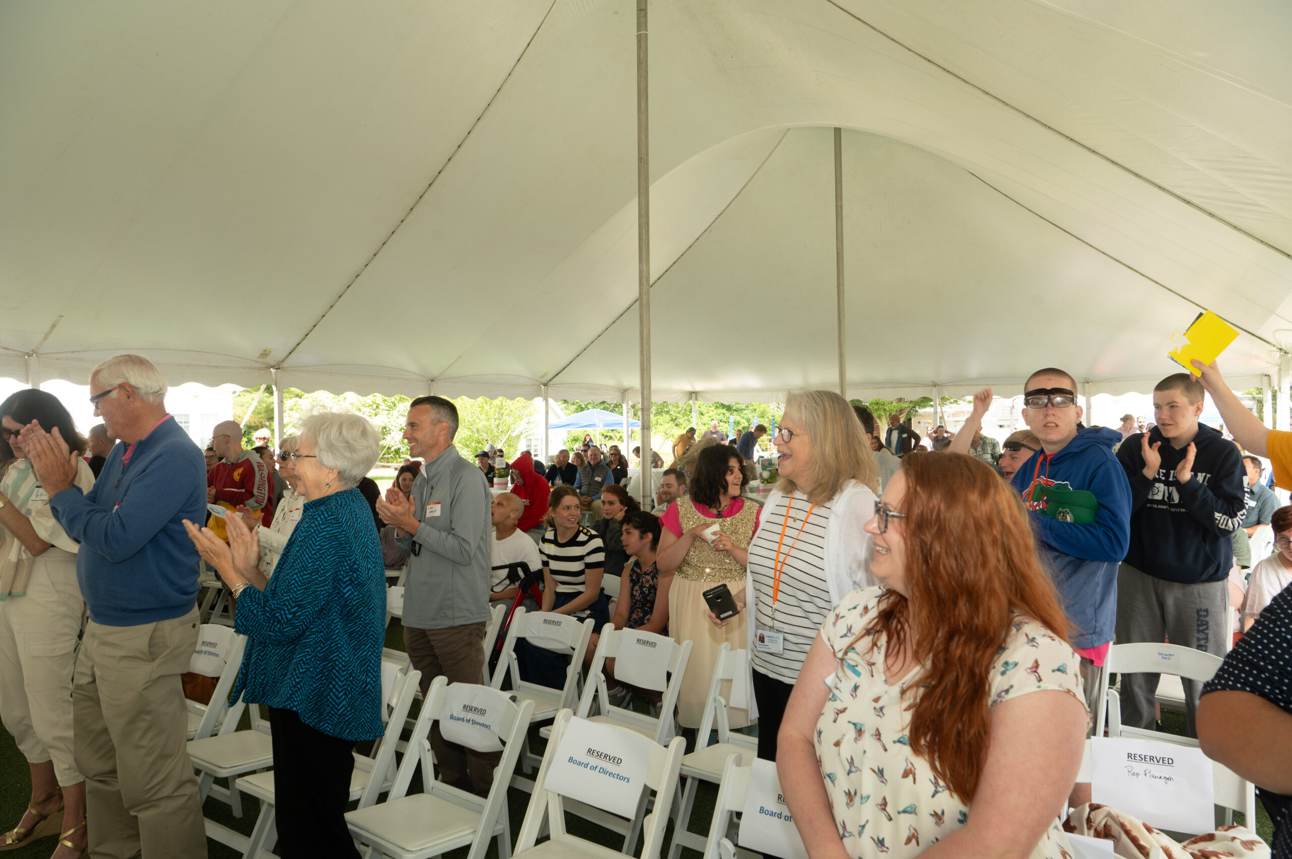 Group of people under a tent during an event.